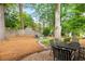 Spacious backyard featuring a brick patio, fire pit, and swing set, perfect for outdoor entertaining at 2342 Eastway Rd, Decatur, GA 30033