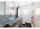 Modern bathroom featuring a glass bowl sink, mosaic backsplash, and colorful shower curtain at 2342 Eastway Rd, Decatur, GA 30033