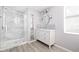 Bright bathroom featuring a glass-enclosed shower, white vanity, and modern fixtures at 2342 Eastway Rd, Decatur, GA 30033
