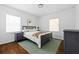Cozy bedroom with hardwood floors, two windows, and neutral decor at 2342 Eastway Rd, Decatur, GA 30033