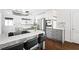Modern kitchen featuring gray and white cabinetry, a center island with bar seating, and stainless steel appliances at 2342 Eastway Rd, Decatur, GA 30033