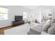 Bright living room with hardwood floors, neutral decor, and abundant natural light from large windows at 2342 Eastway Rd, Decatur, GA 30033