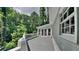 Covered back porch with a light blue railing and home siding with many large trees at 2976 Matthew Ln, Lawrenceville, GA 30044