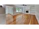 Spacious living room with hardwood floors, a fireplace, built-in shelves, and French doors at 2976 Matthew Ln, Lawrenceville, GA 30044