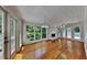 Sunroom or living room featuring gleaming hardwood floors, a fireplace and lots of windows at 2976 Matthew Ln, Lawrenceville, GA 30044
