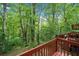 Lovely backyard deck with outdoor furniture overlooking the peaceful lush landscape at 4514 Creekwood Nw Cir, Kennesaw, GA 30152