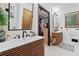 Modern bathroom with double sink vanity, sleek fixtures, and walk-in closet at 4514 Creekwood Nw Cir, Kennesaw, GA 30152