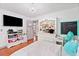 Bedroom with hardwood floors, a queen-sized bed, a mounted TV, white walls, and colorful decor at 4514 Creekwood Nw Cir, Kennesaw, GA 30152