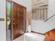 Elegant entryway with a wooden door, striking tapestry and white tile flooring that offers a luxurious welcome at 4514 Creekwood Nw Cir, Kennesaw, GA 30152
