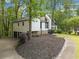 View of contemporary style home featuring a two-car garage and landscaped yard at 4514 Creekwood Nw Cir, Kennesaw, GA 30152