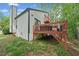 Side exterior view of a home with an attached deck and green surroundings at 4514 Creekwood Nw Cir, Kennesaw, GA 30152