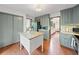 Spacious kitchen with a center island, painted cabinets, and hardwood floors that creates a warm cooking environment at 4514 Creekwood Nw Cir, Kennesaw, GA 30152