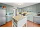 Well-lit kitchen with grey cabinets, granite countertops, stainless steel appliances, and a functional center island at 4514 Creekwood Nw Cir, Kennesaw, GA 30152