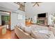 Bright living room with stone fireplace, hardwood floors and large windows showcasing lush outdoor views at 4514 Creekwood Nw Cir, Kennesaw, GA 30152