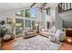 Bright living room features soaring ceilings, a wall of windows and neutral decor with hardwood floors and area rug at 4514 Creekwood Nw Cir, Kennesaw, GA 30152