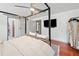 Calm and spacious primary bedroom with four-poster bed and natural lighting at 4514 Creekwood Nw Cir, Kennesaw, GA 30152