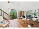 Sunlit home office with hardwood floors and lush backyard views at 4514 Creekwood Nw Cir, Kennesaw, GA 30152