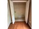 Walk-in closet featuring shelving and hanging space, with hardwood flooring outside at 1466 Dolcetto Nw Trce # 18, Kennesaw, GA 30152