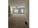 Bright living room features neutral walls, carpet, and a ceiling fan at 1466 Dolcetto Nw Trce # 18, Kennesaw, GA 30152