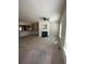 This open concept living room has a fireplace, ceiling fan, and connects to the kitchen at 1466 Dolcetto Nw Trce # 18, Kennesaw, GA 30152