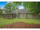 Backyard with a home, screened porch, and trees at 1642 Ashmar Sw Ln, Marietta, GA 30064