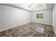 Bedroom with tray ceilings, ceiling fan, a window, and tiled floors at 1642 Ashmar Sw Ln, Marietta, GA 30064