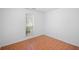 Bright bedroom featuring tile floors, a window with blinds, and neutral walls at 1642 Ashmar Sw Ln, Marietta, GA 30064