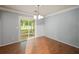 Bright dining area with wood floors, stylish light fixture, and sliding doors to the backyard at 1642 Ashmar Sw Ln, Marietta, GA 30064