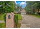 Well-maintained home exterior with brick mailbox and driveway leading to a two-car garage at 1642 Ashmar Sw Ln, Marietta, GA 30064