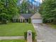 Charming home with brick and siding exterior, well-manicured lawn, and mature trees at 1642 Ashmar Sw Ln, Marietta, GA 30064