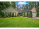 Charming single story home featuring a lush green lawn and mature landscaping at 1642 Ashmar Sw Ln, Marietta, GA 30064