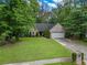 Well-maintained front yard featuring lush green grass and a charming brick and siding home at 1642 Ashmar Sw Ln, Marietta, GA 30064