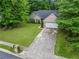 Green home with tidy landscaping, brick accents, and a two-car garage at 1642 Ashmar Sw Ln, Marietta, GA 30064