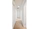 Hallway with carpet flooring and white walls, showcasing multiple doors and trim details at 1642 Ashmar Sw Ln, Marietta, GA 30064