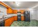 Efficient kitchen with black appliances, wood cabinets, and eye-catching tile floor at 1642 Ashmar Sw Ln, Marietta, GA 30064