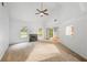 Bright, open-concept living room featuring a fireplace and neutral carpeting with an open doorway to the dining room at 1642 Ashmar Sw Ln, Marietta, GA 30064