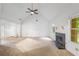 Spacious living room featuring a fireplace, high ceilings, ceiling fan, and natural light at 1642 Ashmar Sw Ln, Marietta, GA 30064