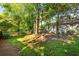 Serene backyard featuring mature trees, a wooden fence, and a sprawling lawn perfect for outdoor enjoyment at 1761 Flat Shoals Se Rd, Atlanta, GA 30316