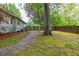 Large, grassy backyard with a stone path and privacy fence at 1761 Flat Shoals Se Rd, Atlanta, GA 30316
