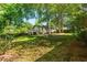 A lush backyard is framed by mature trees, offering shade and privacy, as well as a large deck at 1761 Flat Shoals Se Rd, Atlanta, GA 30316