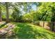 Expansive backyard with lush green grass, mature trees, and a stone pathway for serene outdoor living at 1761 Flat Shoals Se Rd, Atlanta, GA 30316