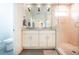 Bright bathroom featuring a double vanity with marble countertop and a glass enclosed shower at 1761 Flat Shoals Se Rd, Atlanta, GA 30316