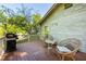 Outdoor deck with chairs, a table, and a grill with views of the yard at 1761 Flat Shoals Se Rd, Atlanta, GA 30316