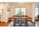 Bright dining room with wood table and chairs is illuminated by a large window at 1761 Flat Shoals Se Rd, Atlanta, GA 30316