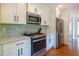The kitchen has marble counters, stainless steel appliances, and sleek white cabinets at 1761 Flat Shoals Se Rd, Atlanta, GA 30316