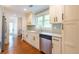 The updated kitchen has a stainless steel dishwasher, and sleek white cabinets at 1761 Flat Shoals Se Rd, Atlanta, GA 30316