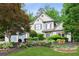 Charming two-story home featuring manicured landscaping, flowering shrubs, and a well-maintained lawn at 2437 Camden Lake Nw Vw, Acworth, GA 30101