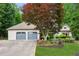 Beautiful home featuring a three-car garage, well-manicured lawn, and colorful landscaping at 2437 Camden Lake Nw Vw, Acworth, GA 30101