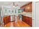 Spacious kitchen with stainless steel appliances, granite countertops, and wood flooring at 2437 Camden Lake Nw Vw, Acworth, GA 30101