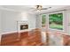 Inviting living room features a cozy fireplace, large windows, and gleaming hardwood floors at 2437 Camden Lake Nw Vw, Acworth, GA 30101